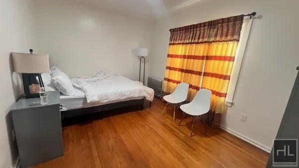 a bedroom with a bed and a window