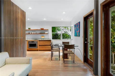 a kitchen with stainless steel appliances granite countertop a sink a stove and wooden floor