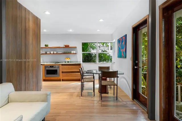 a kitchen with stainless steel appliances granite countertop a sink a stove and wooden floor