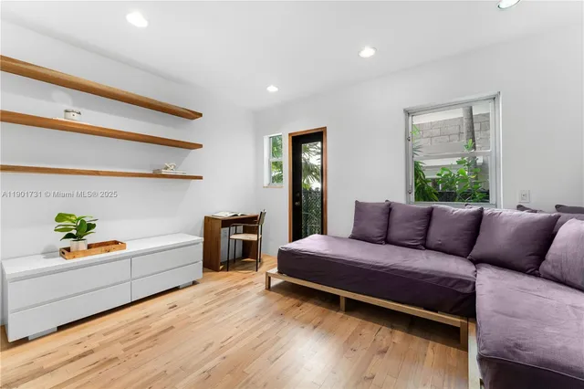 a living room with a bed furniture and a window