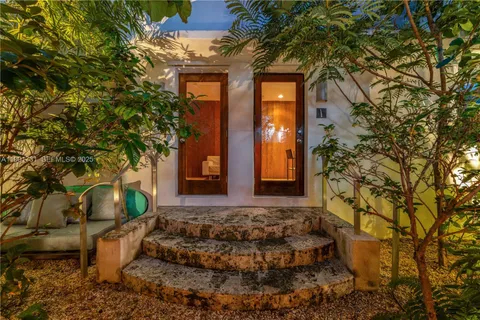 a view of a house with potted plants
