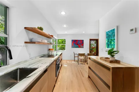 a kitchen with stainless steel appliances a stove and more cabinets