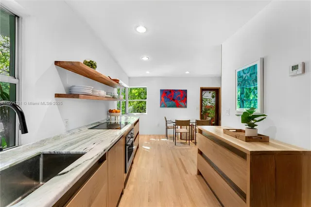 a kitchen with stainless steel appliances a stove and more cabinets