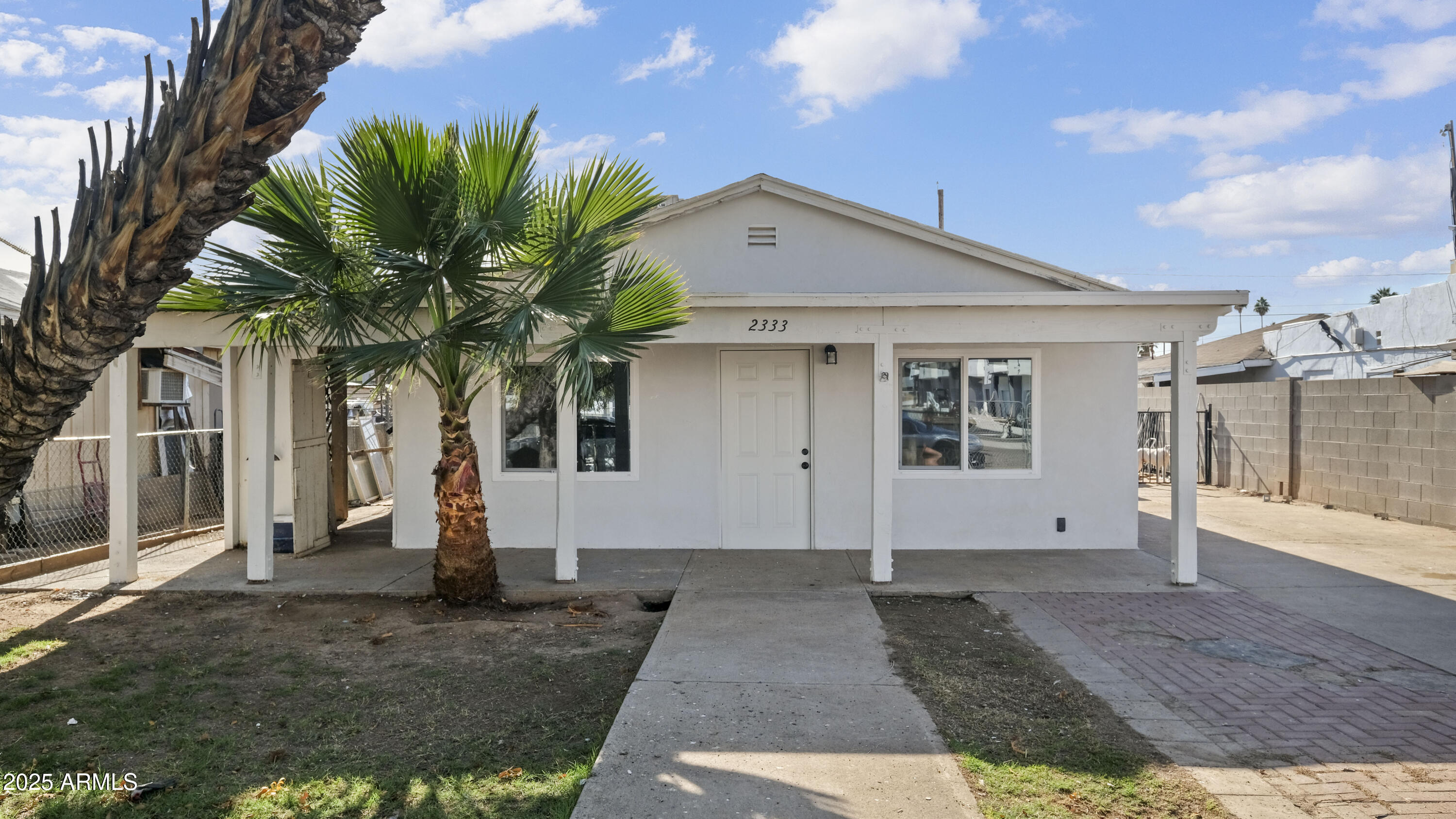 a front view of house with yard and trees