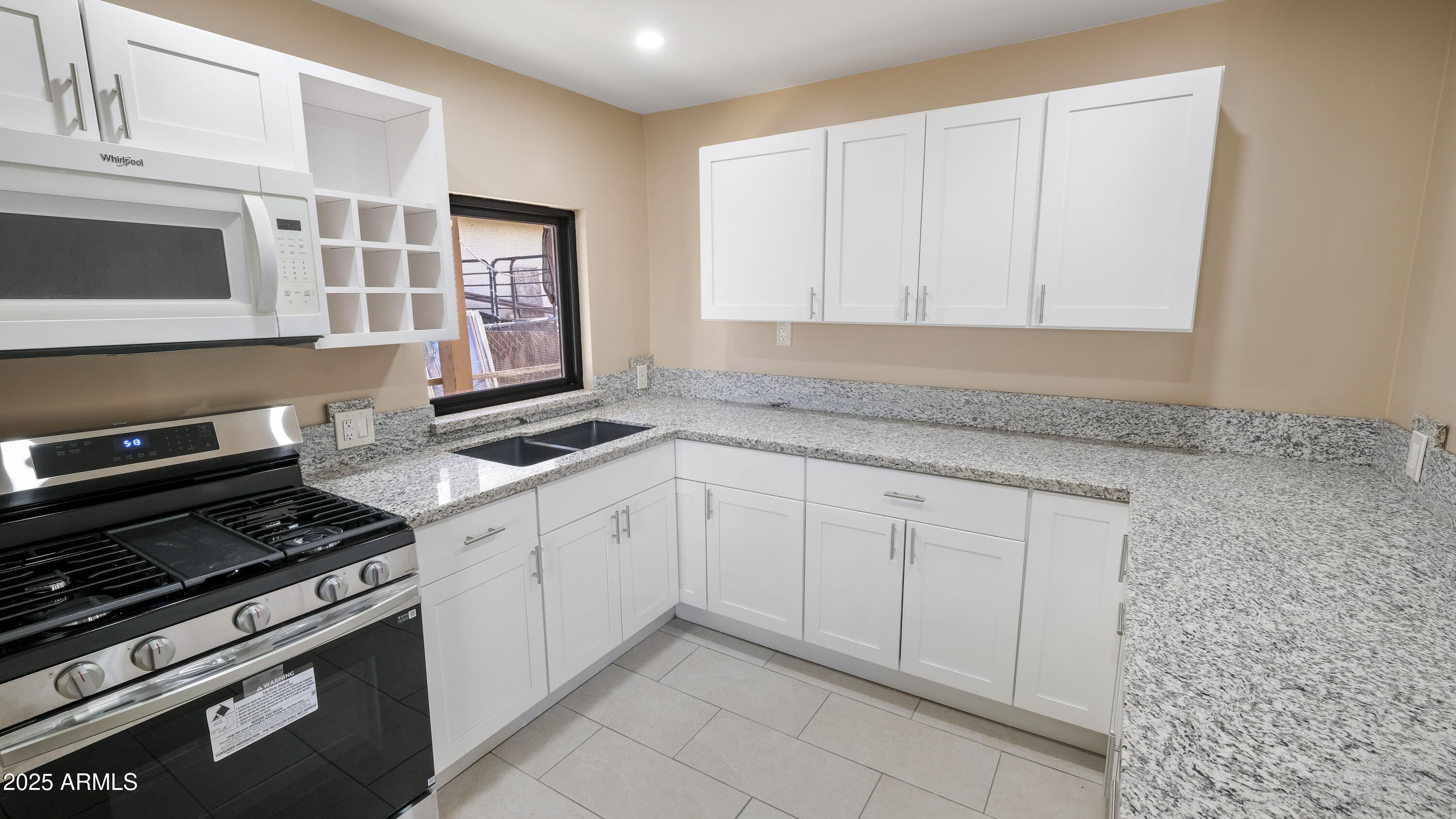 2333 West Coolidge Street Phoenix, AZ 85015 - Photo 2 of 9 a kitchen with granite countertop white cabinets and stainless steel appliances
