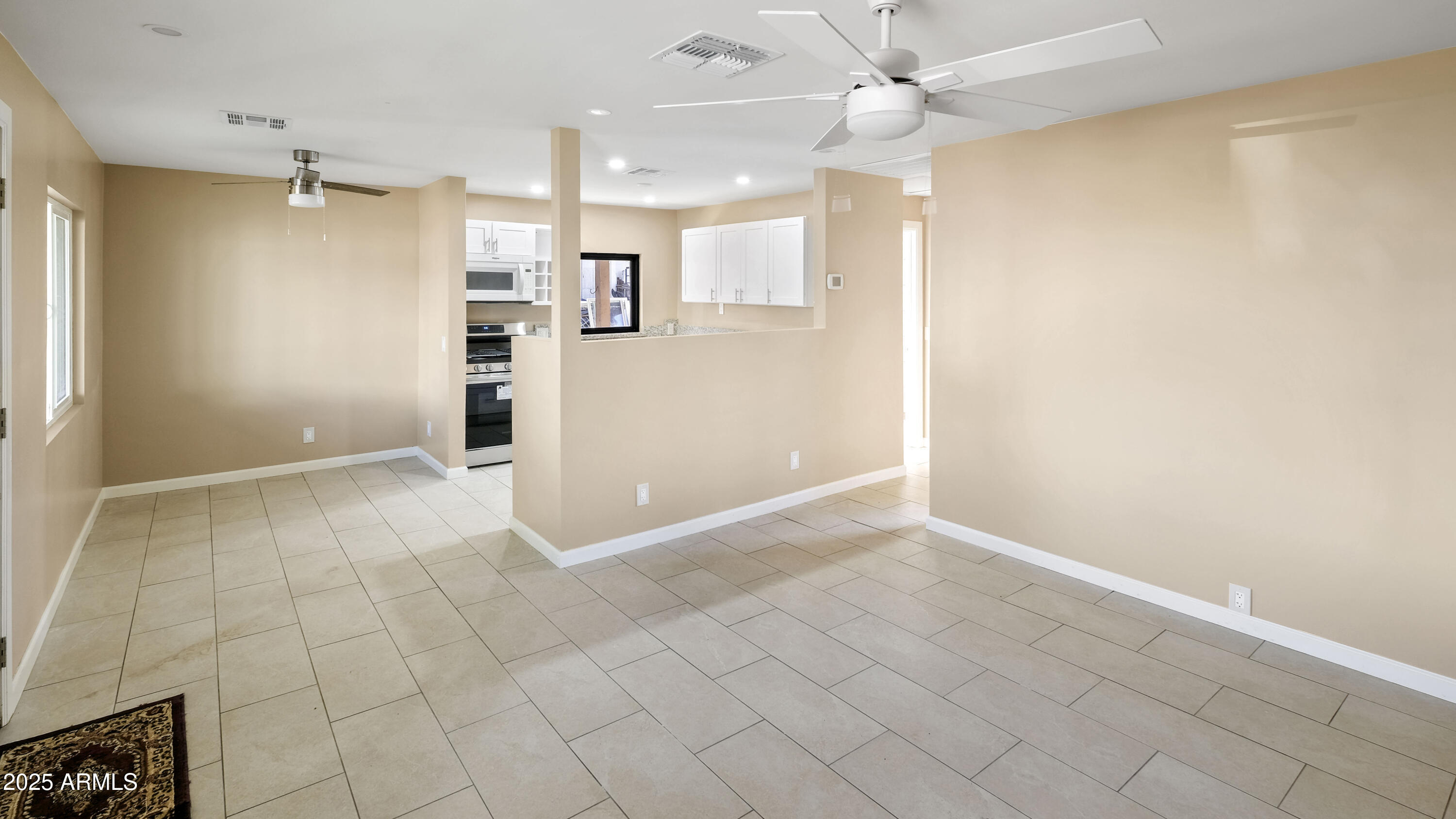 2333 West Coolidge Street Phoenix, AZ 85015 - Photo 6 of 9 an empty room with kitchen view and a window