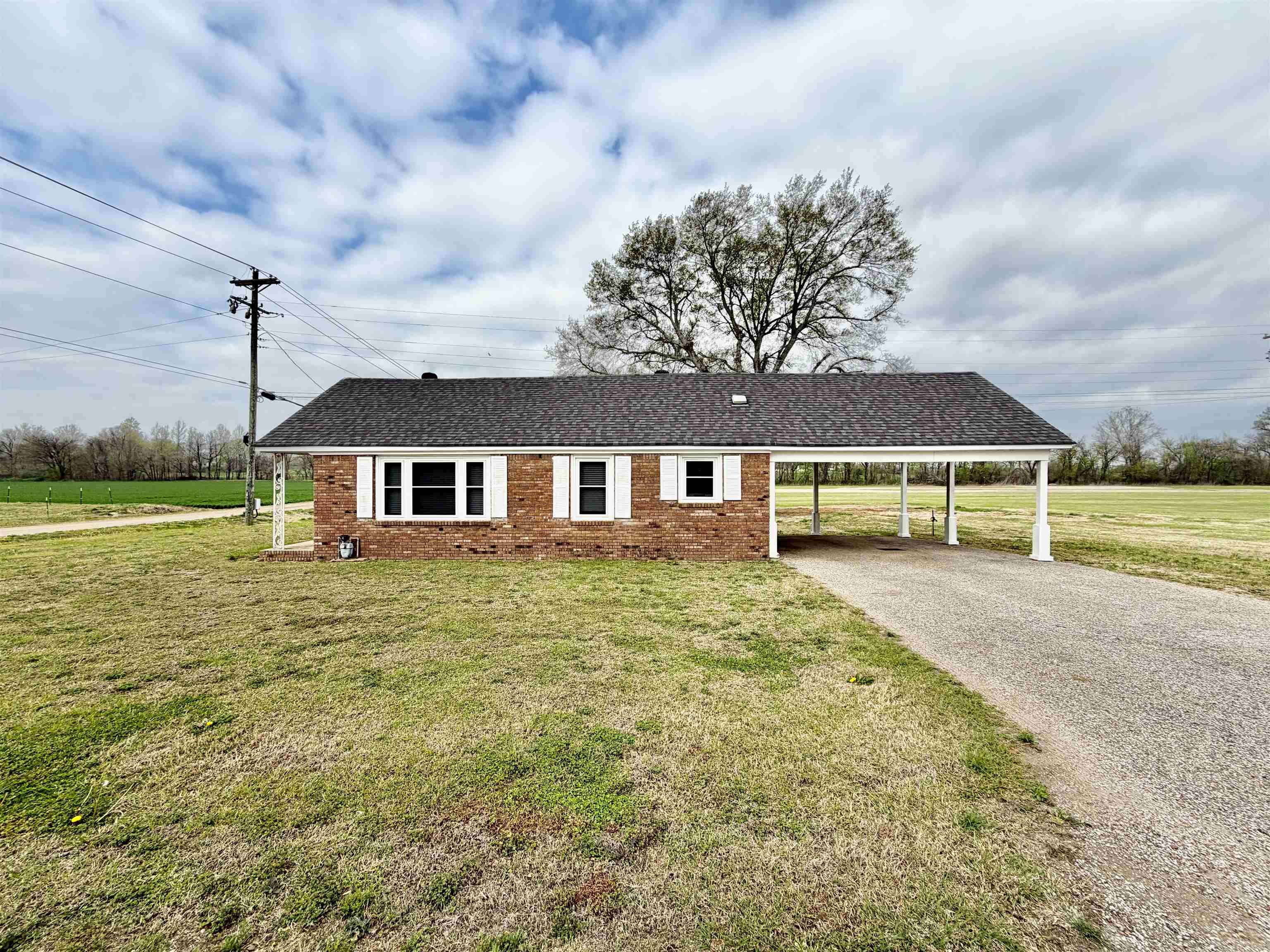 5442 Bride Road Covington, TN 38019 - Photo 5 of 20 a front view of a house with a garden