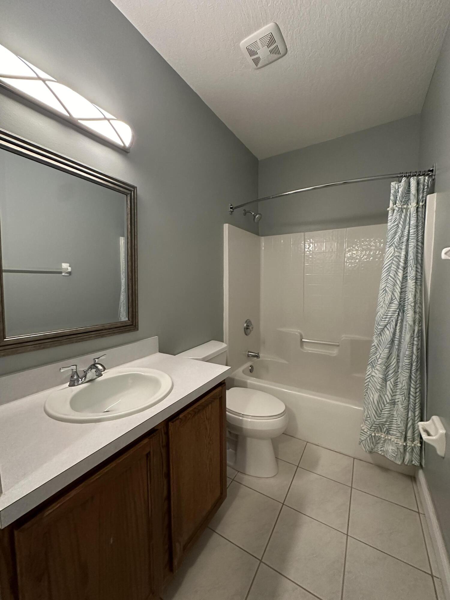 4010 Caparosa Circle Melbourne, FL 32940 - Photo 12 of 20 a bathroom with a sink a toilet and shower
