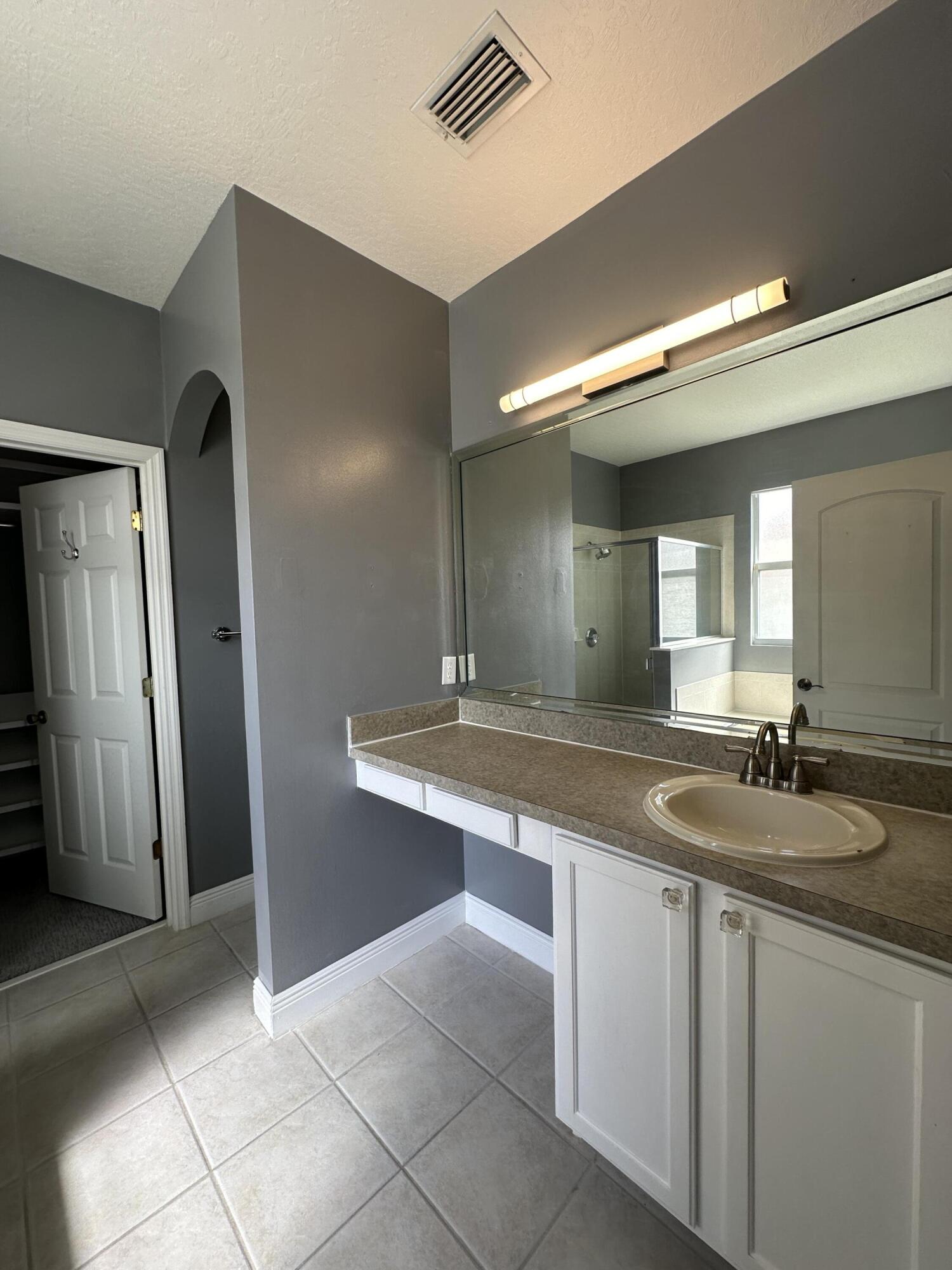 4010 Caparosa Circle Melbourne, FL 32940 - Photo 8 of 20 a bathroom with a sink and a mirror
