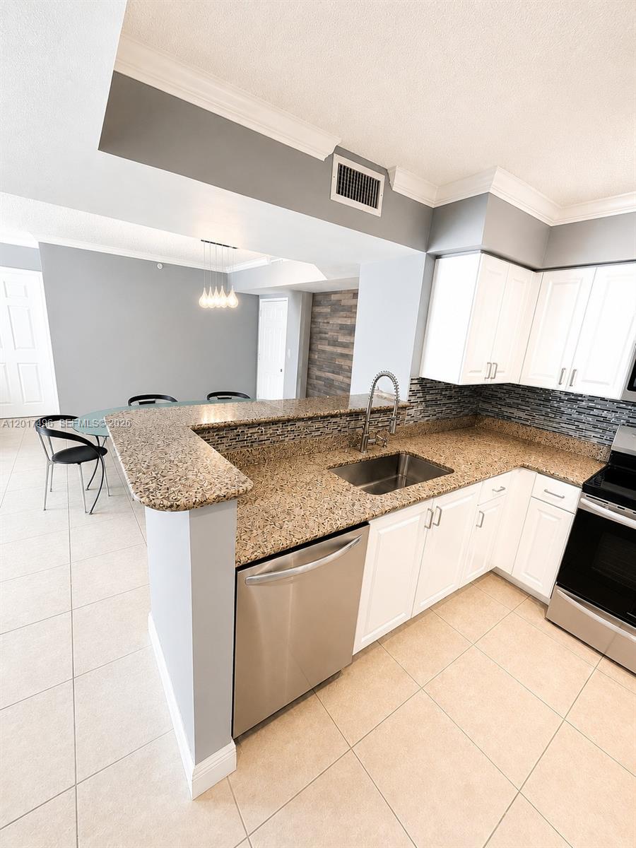 Brickell Miami, FL 33131 - Photo 5 of 19 a kitchen with granite countertop a sink and a stove