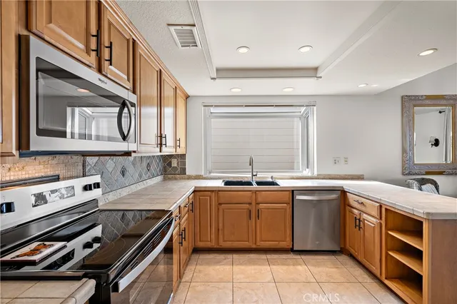 a kitchen with a sink stove and cabinets