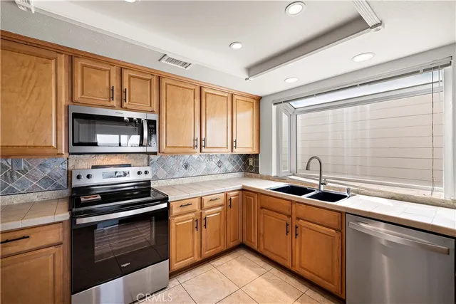 a kitchen with a sink stove and microwave