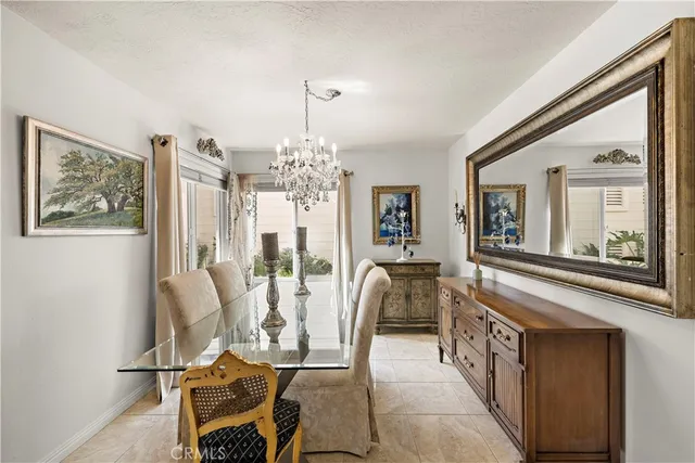 a living room with furniture a chandelier and a large window