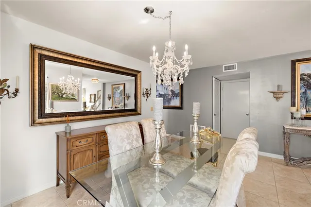 a view of a dining room with furniture and chandelier