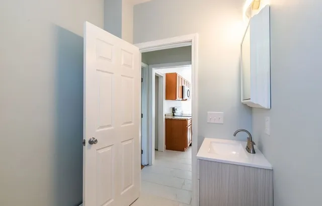 a bathroom with a sink and mirror