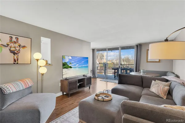 a living room with furniture a couch and a flat screen tv