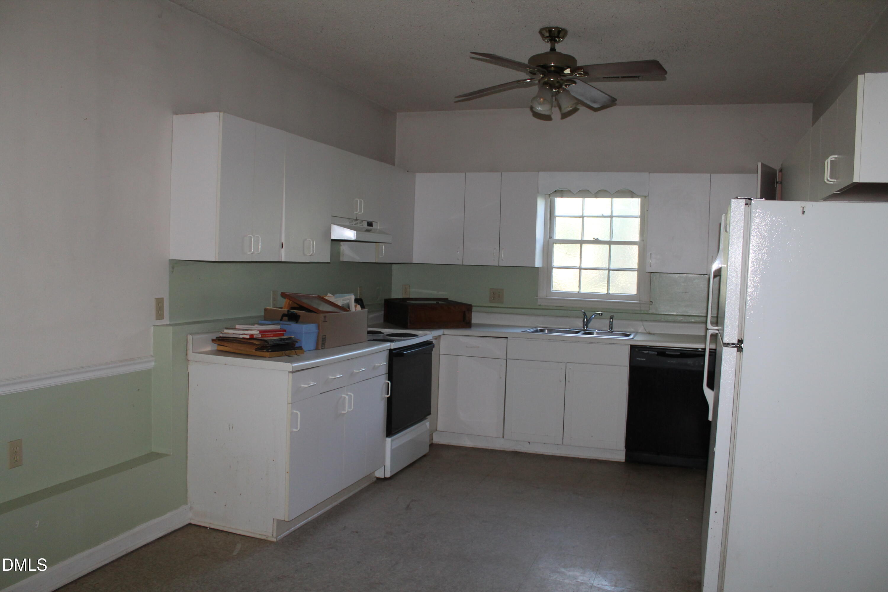 103 Gary Street Raleigh, NC 27606 - Photo 5 of 6 a kitchen with a sink stove and cabinets