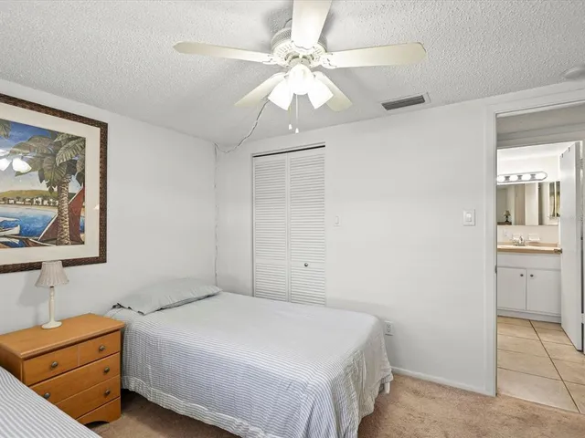 a bedroom with a bed dresser and a chair