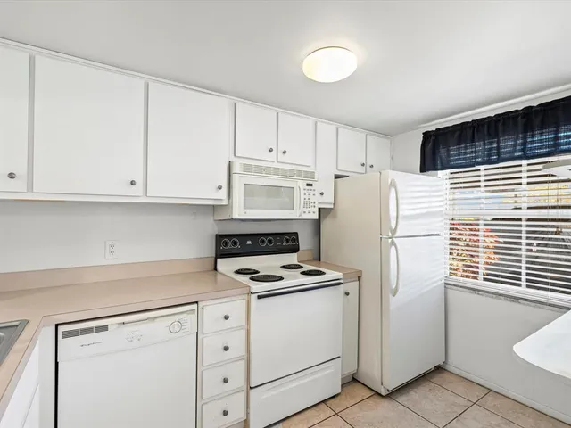 a bedroom with two beds and a chandelier