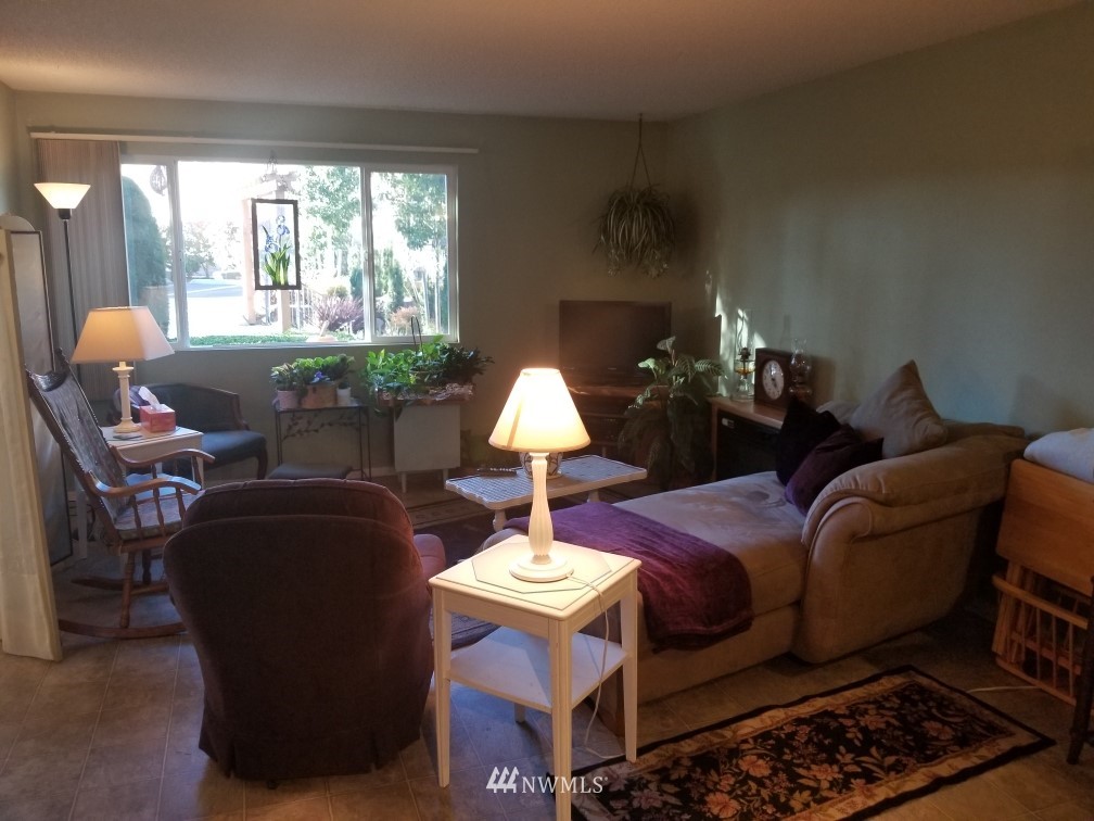 425 45th Street Southwest, Unit 208 Everett, WA 98203 - Photo 3 of 10 a living room with furniture and a chandelier