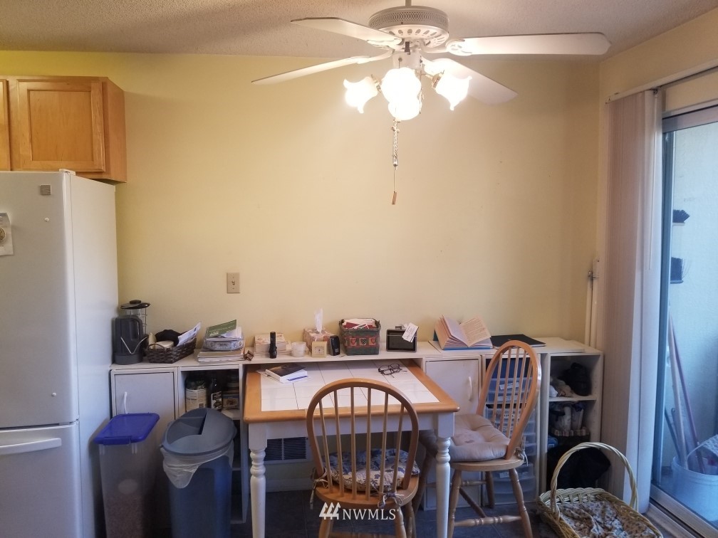 425 45th Street Southwest, Unit 208 Everett, WA 98203 - Photo 4 of 10 a view of a dining room with furniture and chandelier