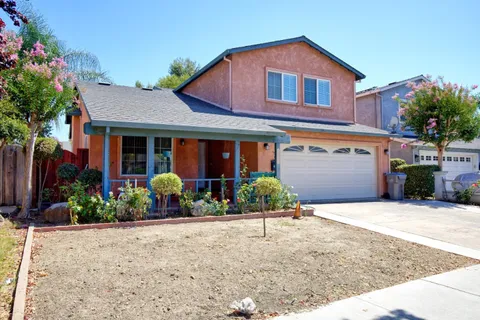 a front view of a house with a yard and a garage