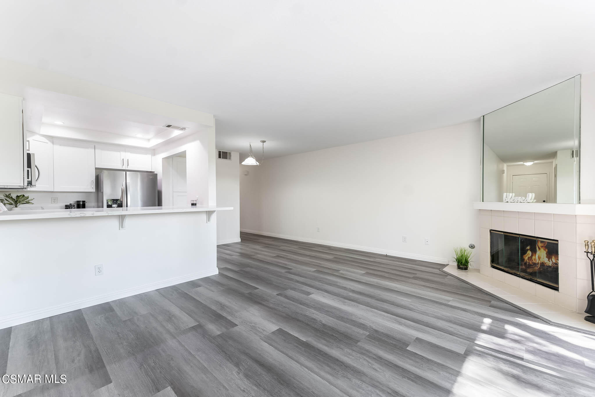 2731 Erringer Road, Unit 54 Simi Valley, CA 93065 - Photo 11 of 34 a view of kitchen living room with wooden floor and fireplace