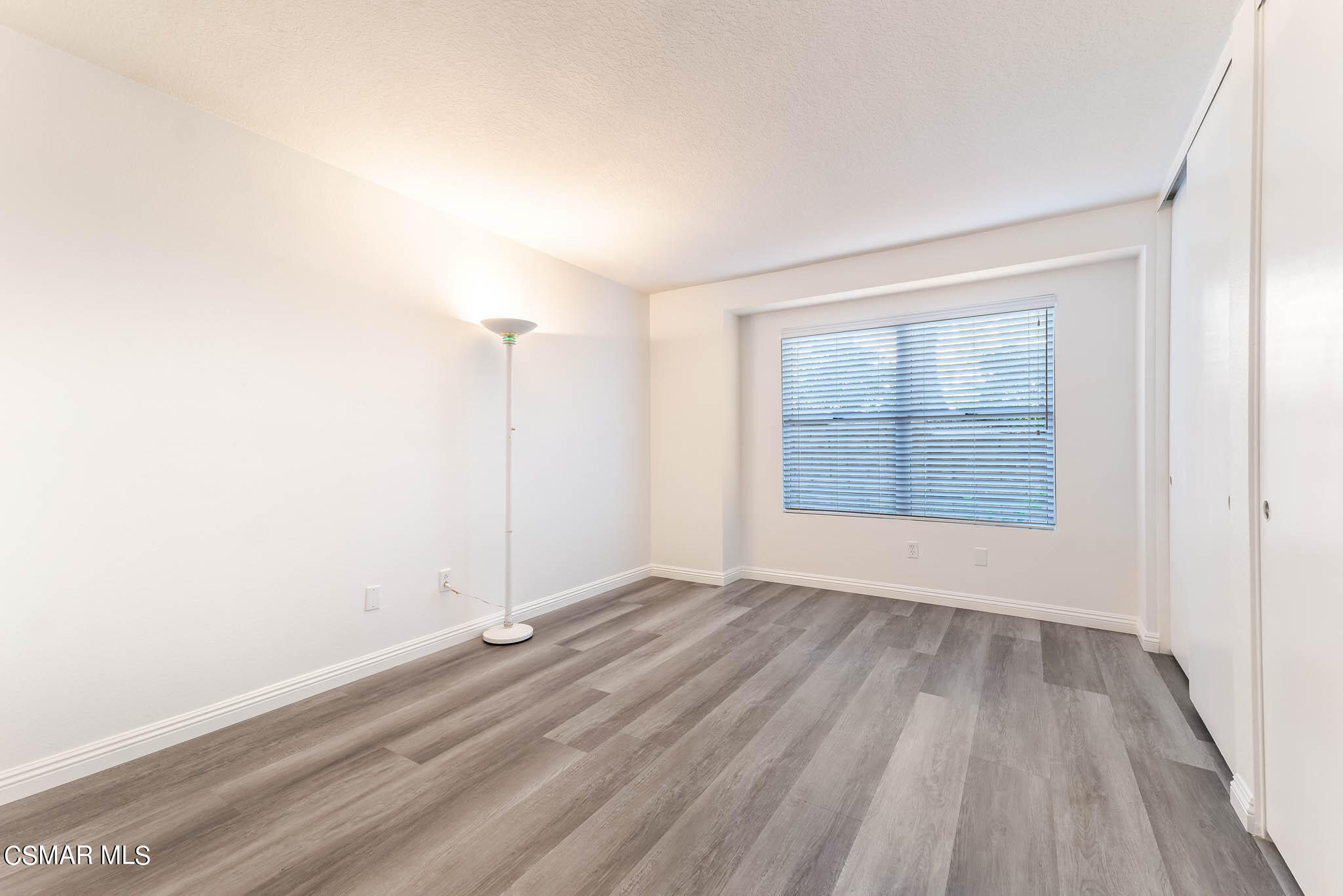 2731 Erringer Road, Unit 54 Simi Valley, CA 93065 - Photo 16 of 34 an empty room with wooden floor and windows