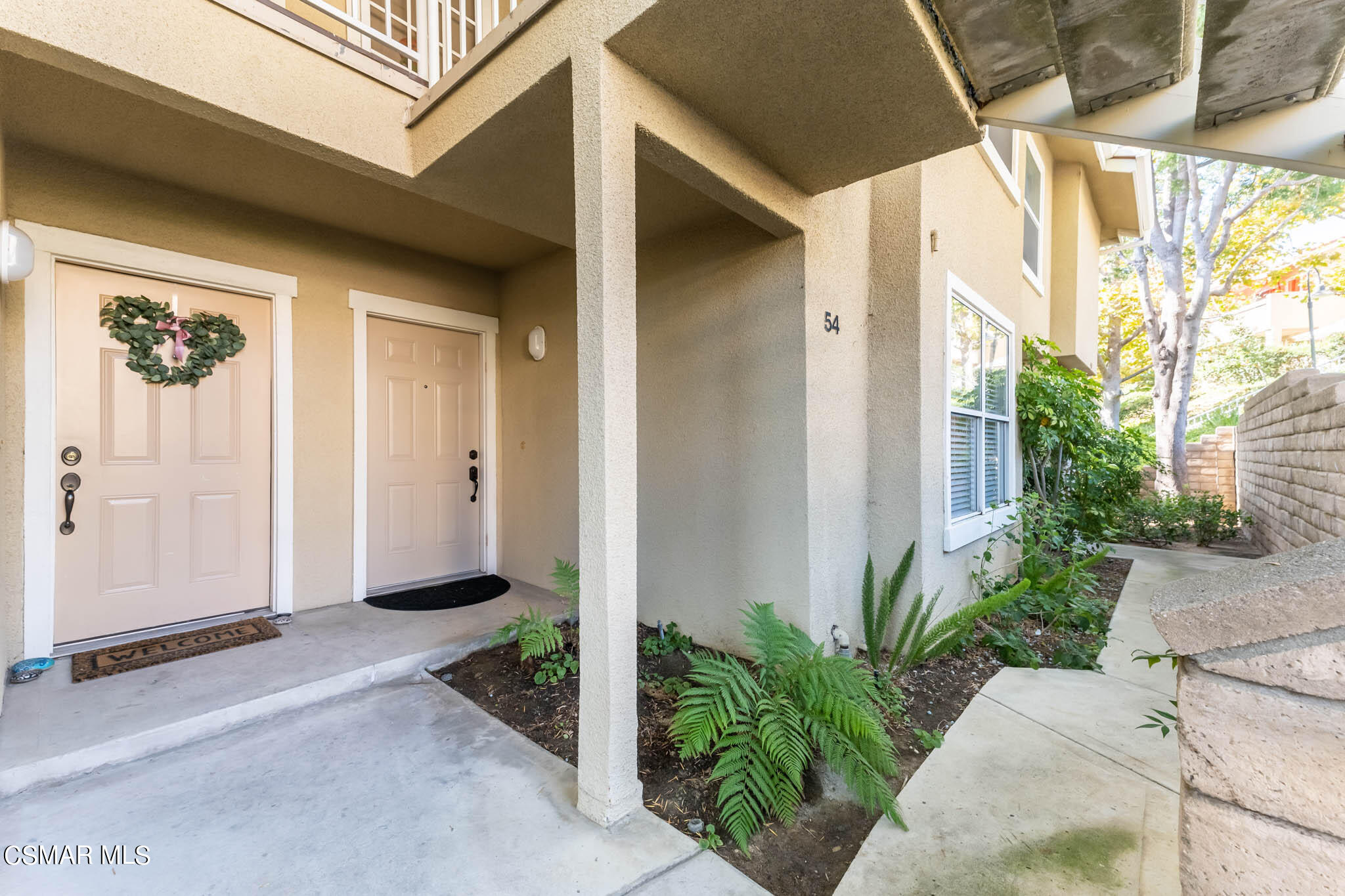 2731 Erringer Road, Unit 54 Simi Valley, CA 93065 - Photo 19 of 34 a front view of a house with a yard