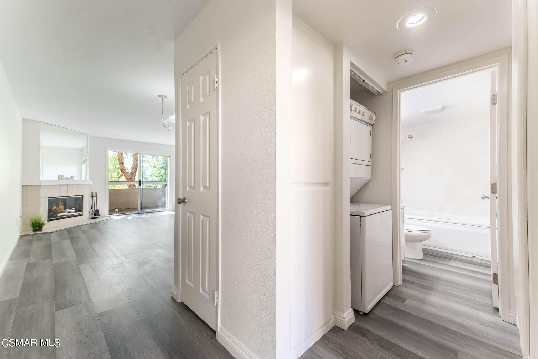 2731 Erringer Road, Unit 54 Simi Valley, CA 93065 - Photo 3 of 34 a view of a hallway with wooden floor and a living room