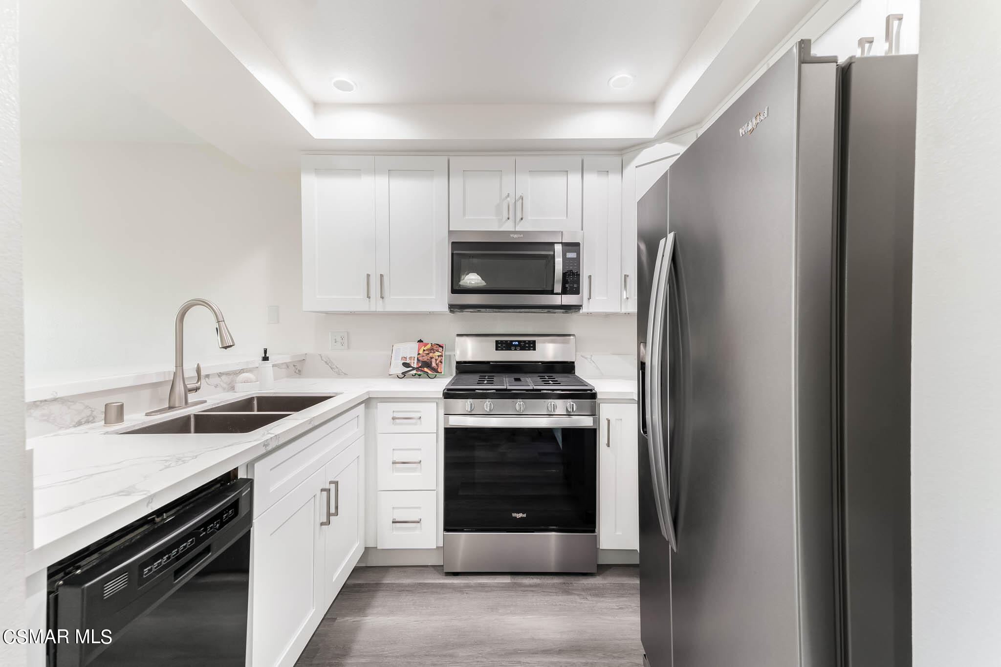 2731 Erringer Road, Unit 54 Simi Valley, CA 93065 - Photo 5 of 34 a kitchen with stainless steel appliances granite countertop a stove a sink and a refrigerator