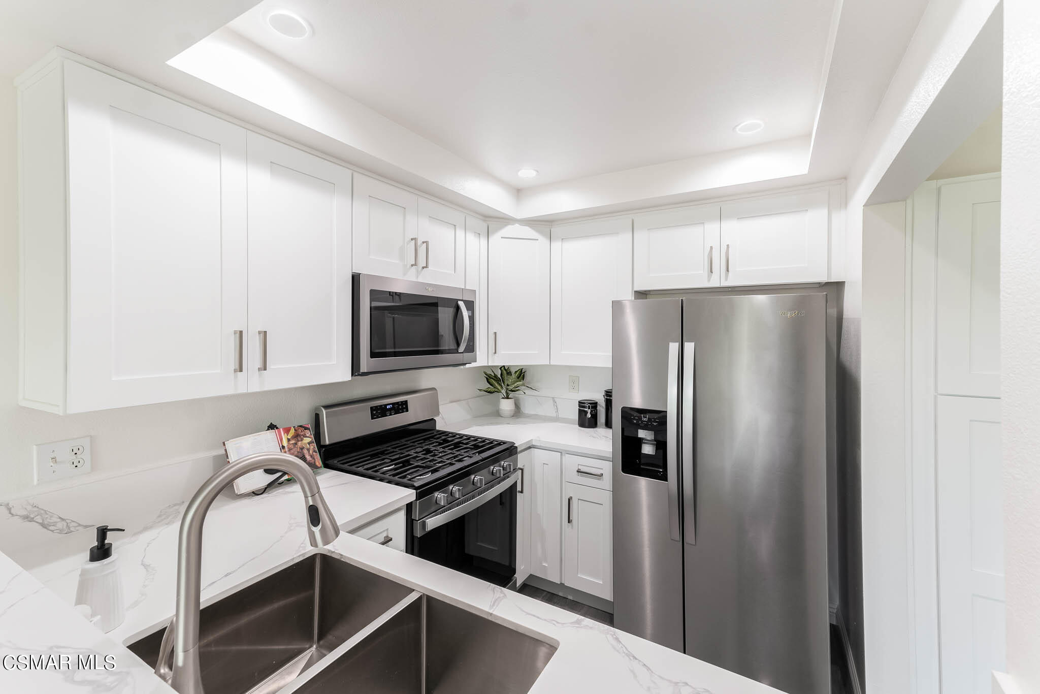 2731 Erringer Road, Unit 54 Simi Valley, CA 93065 - Photo 6 of 34 a kitchen with stainless steel appliances a refrigerator stove and microwave