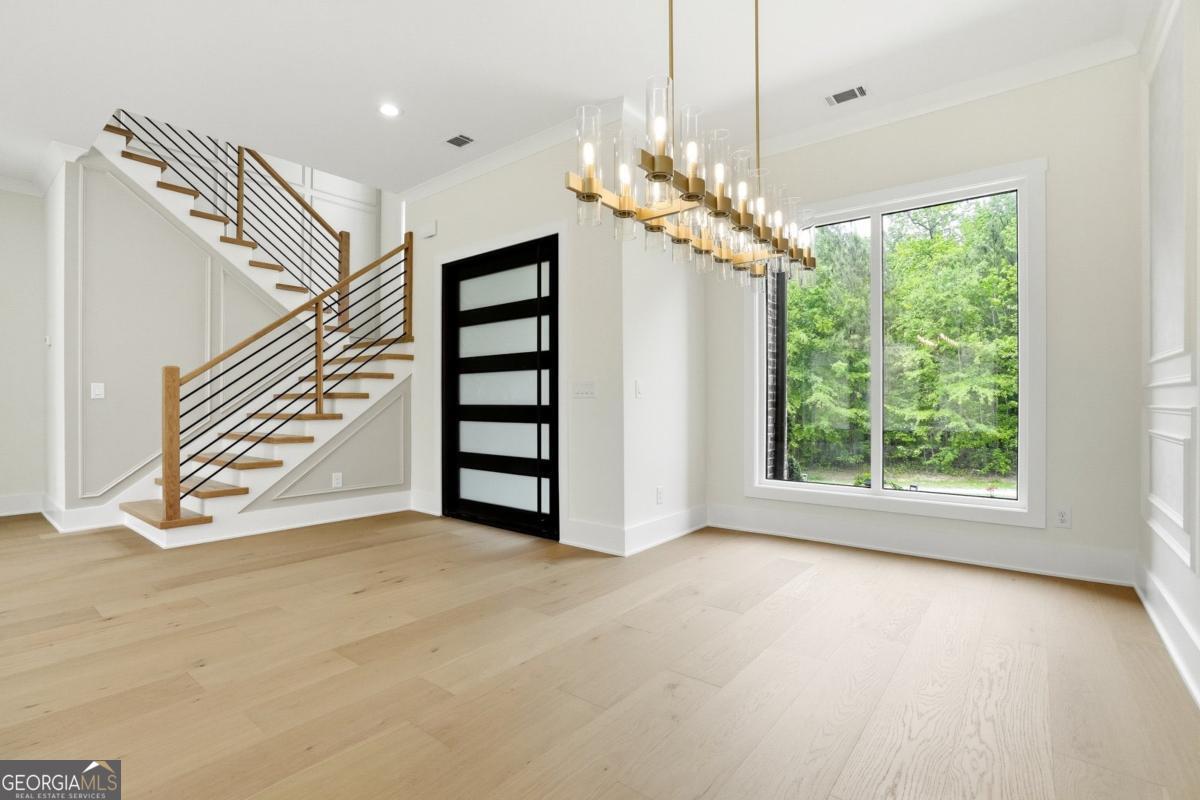 1557 Whitley Road Dacula, GA 30019 - Photo 6 of 46 a view of a room with a large window and chandelier