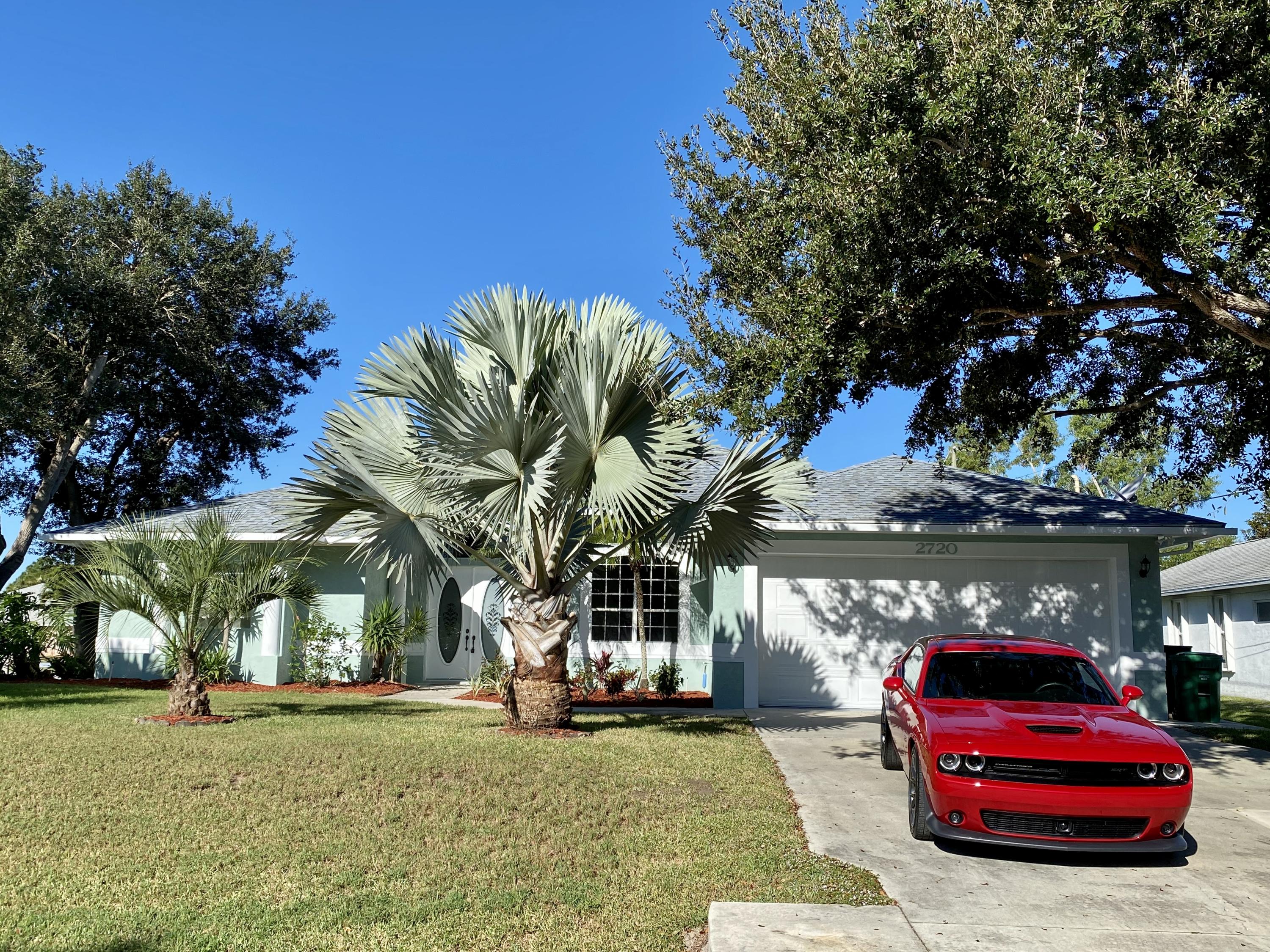 2720 Southeast Kern Road Port St. Lucie, FL 34984 - Photo 1 of 54 Blue sky & palm trees
