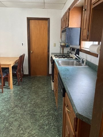 90 Prospect Street, Unit 2 Somerville, MA 02143 - Photo 12 of 27 a kitchen with sink cabinets and a table