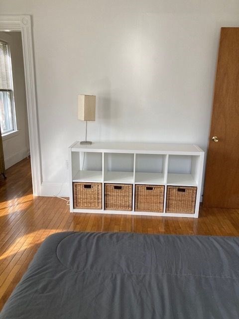 90 Prospect Street, Unit 2 Somerville, MA 02143 - Photo 6 of 27 a view of an empty room with wooden floor and cabinet