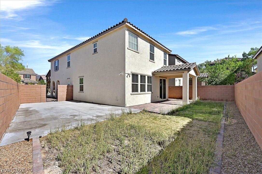 2823 Turnstone Ridge Street Henderson, NV 89044 - Photo 24 of 25 A private rear yard with a covered patio, perfect for outdoor relaxation.
