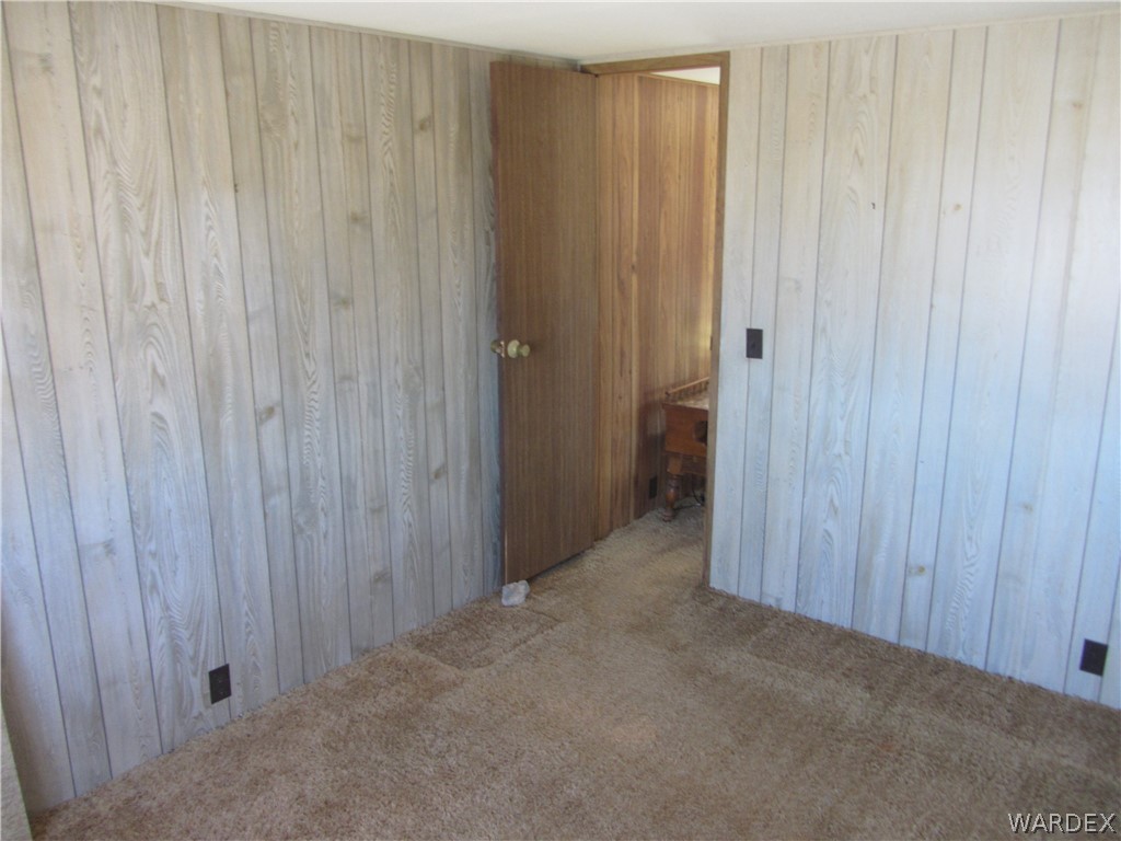 2661 South Jade Road Golden Valley, AZ 86413 - Photo 4 of 21 a view of a closet with wooden walls