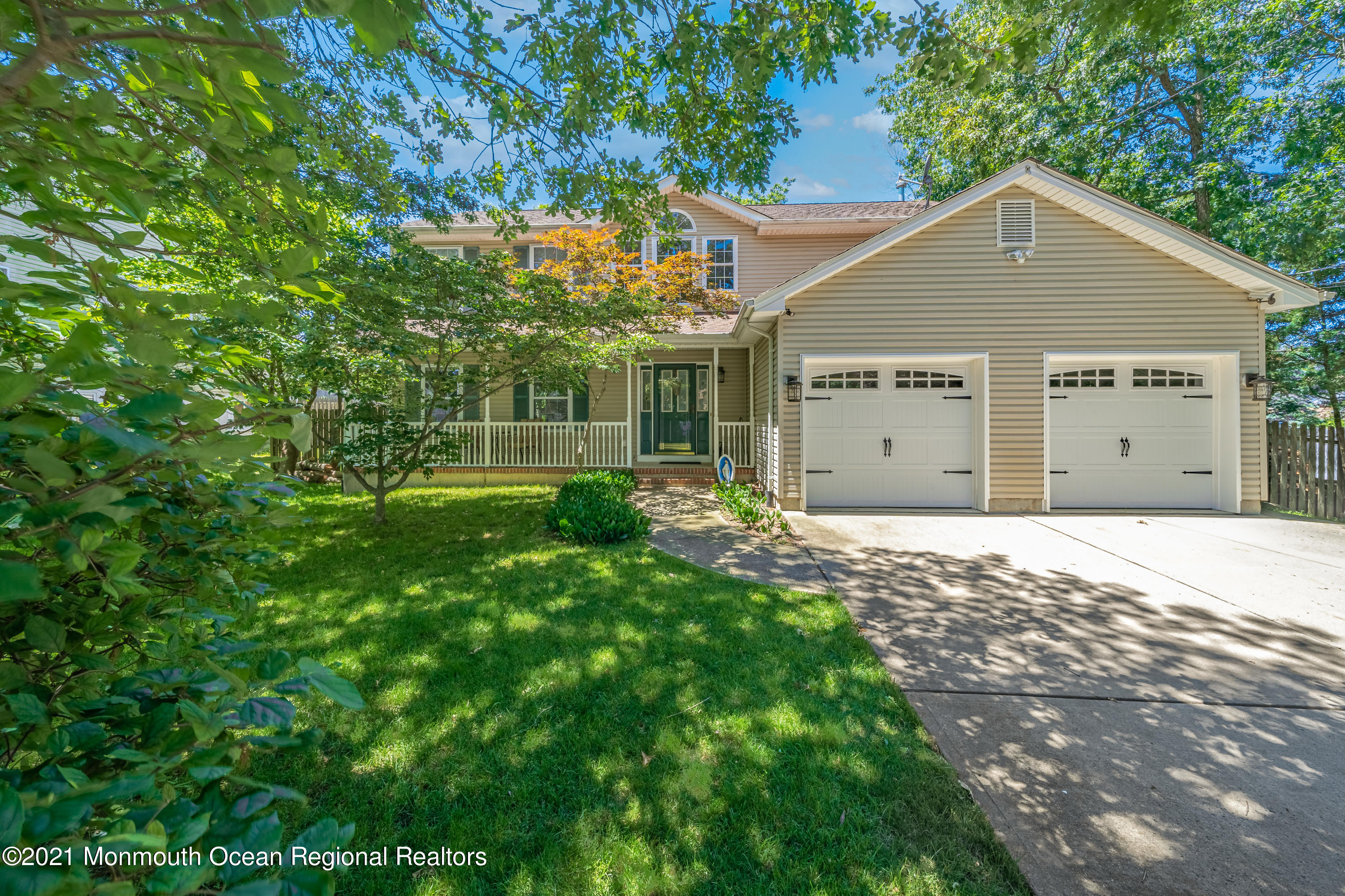 217 Topside Road Manahawkin, NJ 08050 - Photo 2 of 35 a front view of a house with a yard and garage