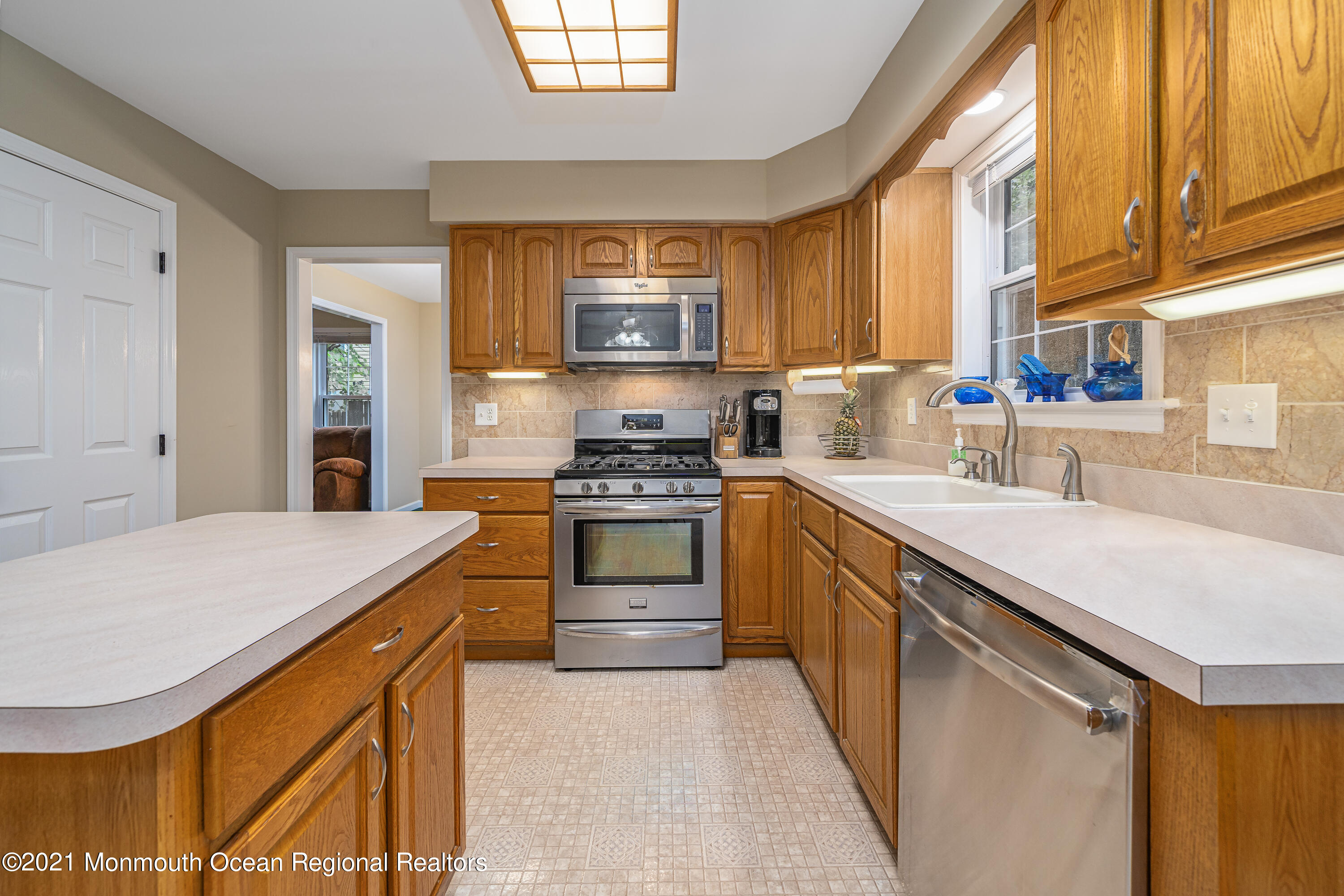 217 Topside Road Manahawkin, NJ 08050 - Photo 13 of 35 a kitchen with stainless steel appliances granite countertop a sink stove and refrigerator