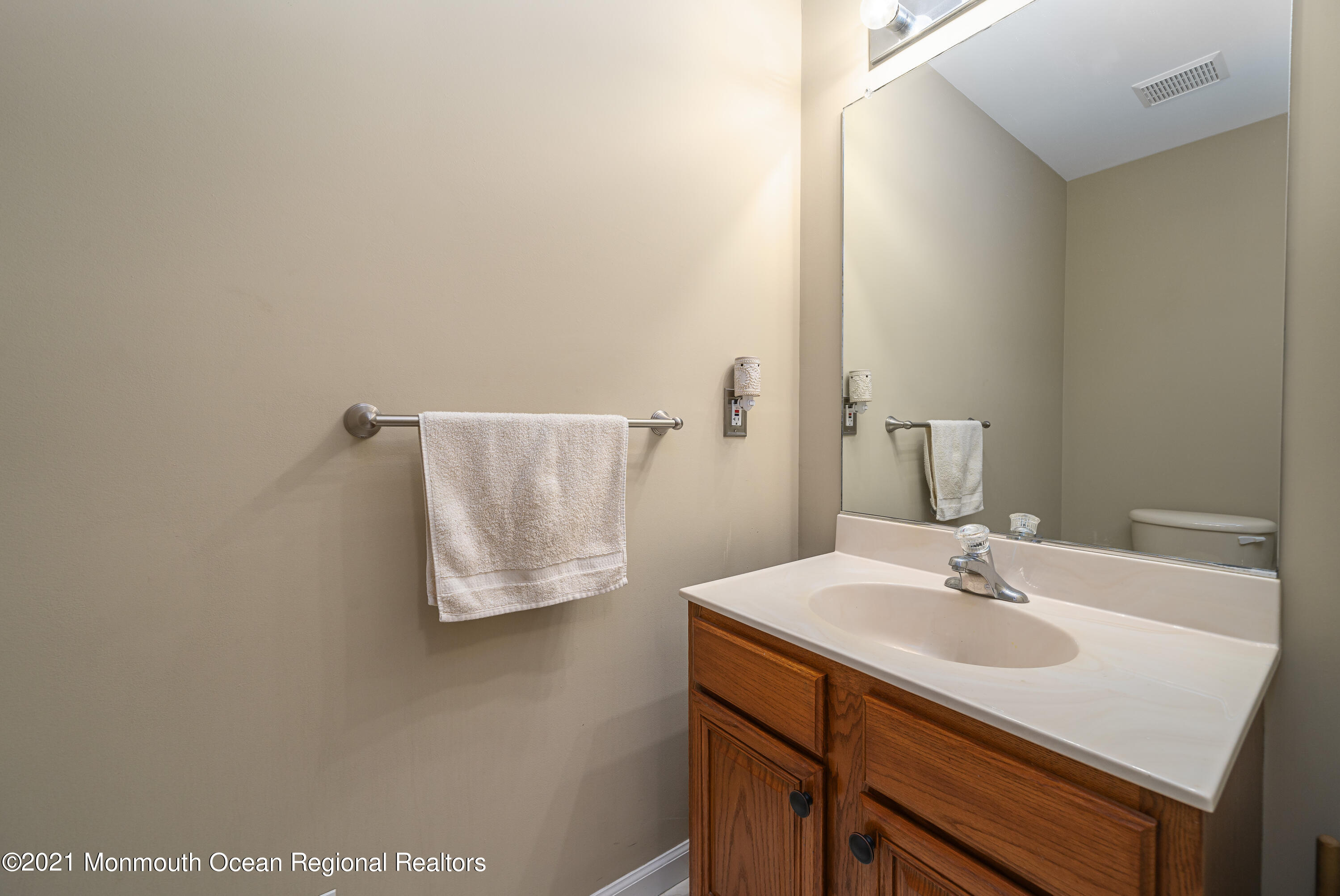 217 Topside Road Manahawkin, NJ 08050 - Photo 17 of 35 a bathroom with a sink and a mirror