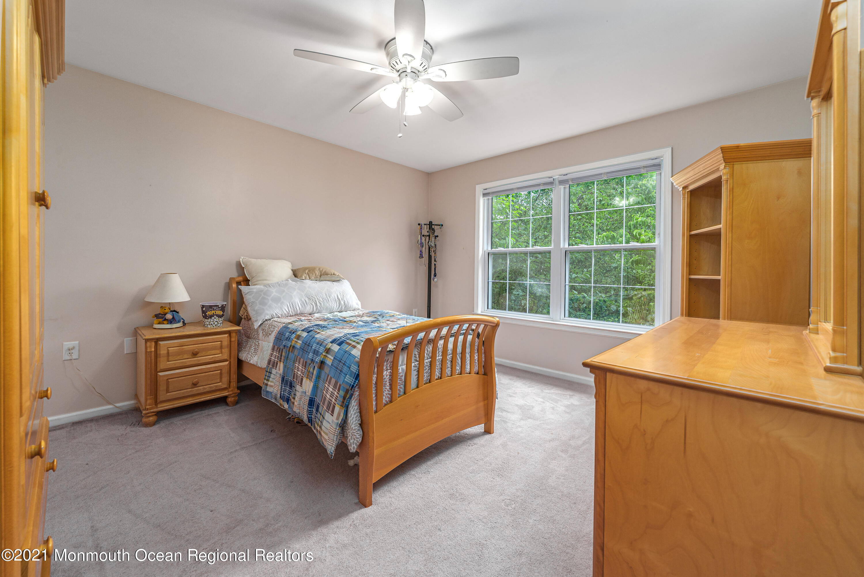 217 Topside Road Manahawkin, NJ 08050 - Photo 21 of 35 a bedroom with a bed and a chandelier