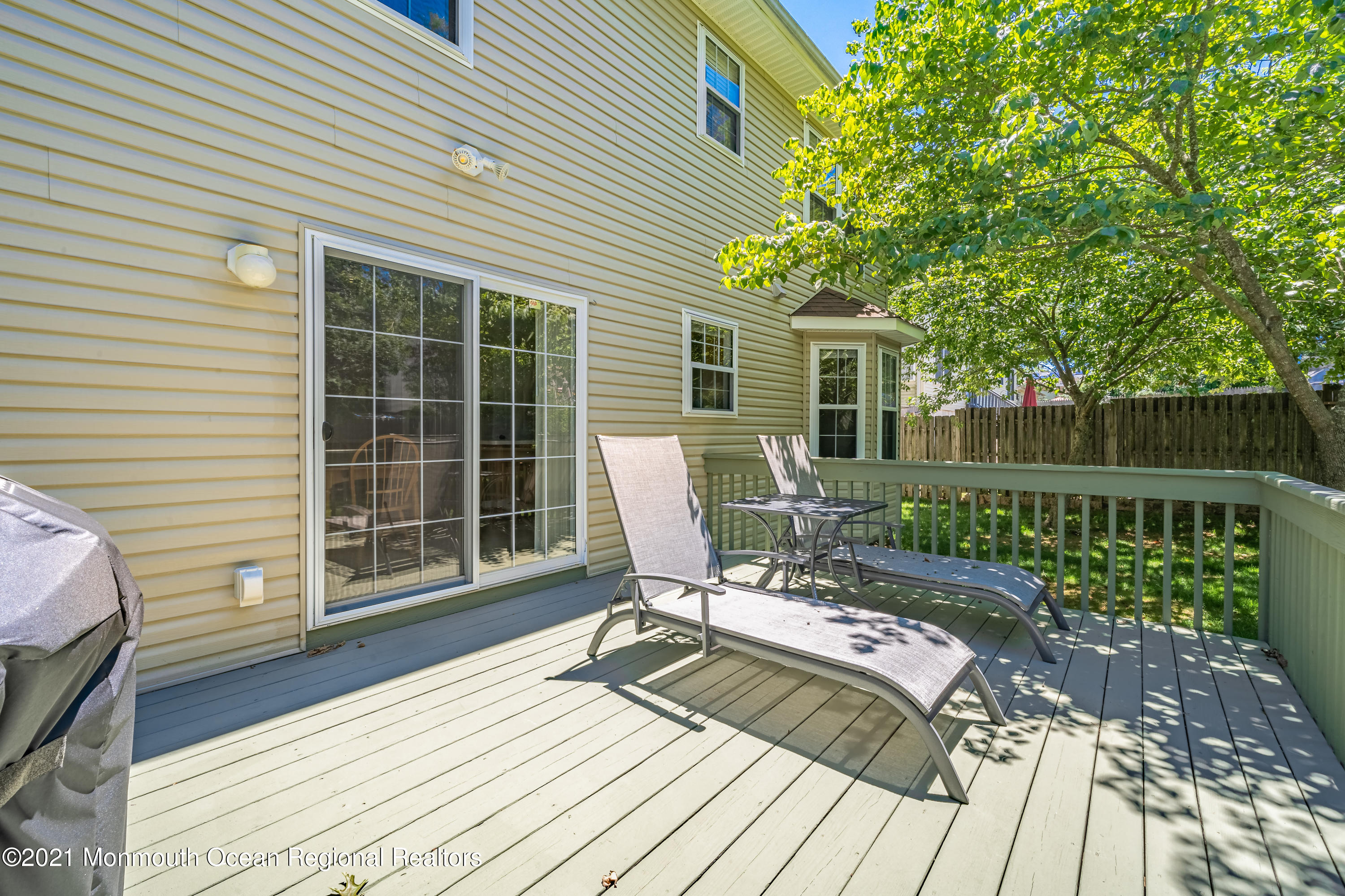 217 Topside Road Manahawkin, NJ 08050 - Photo 27 of 35 a view of a deck with chairs and wooden floor
