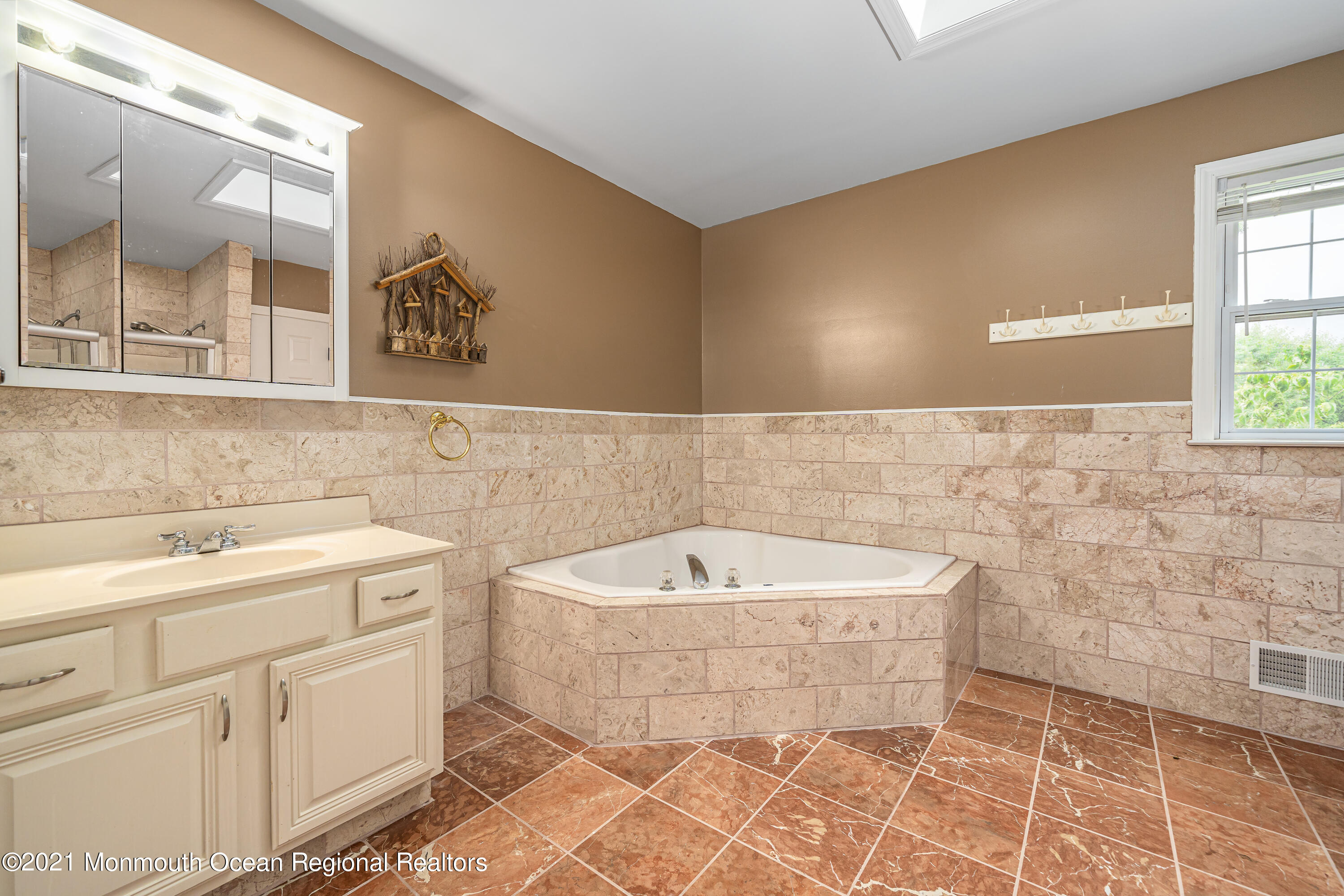217 Topside Road Manahawkin, NJ 08050 - Photo 28 of 35 a bathroom with a sink a mirror and a bathtub