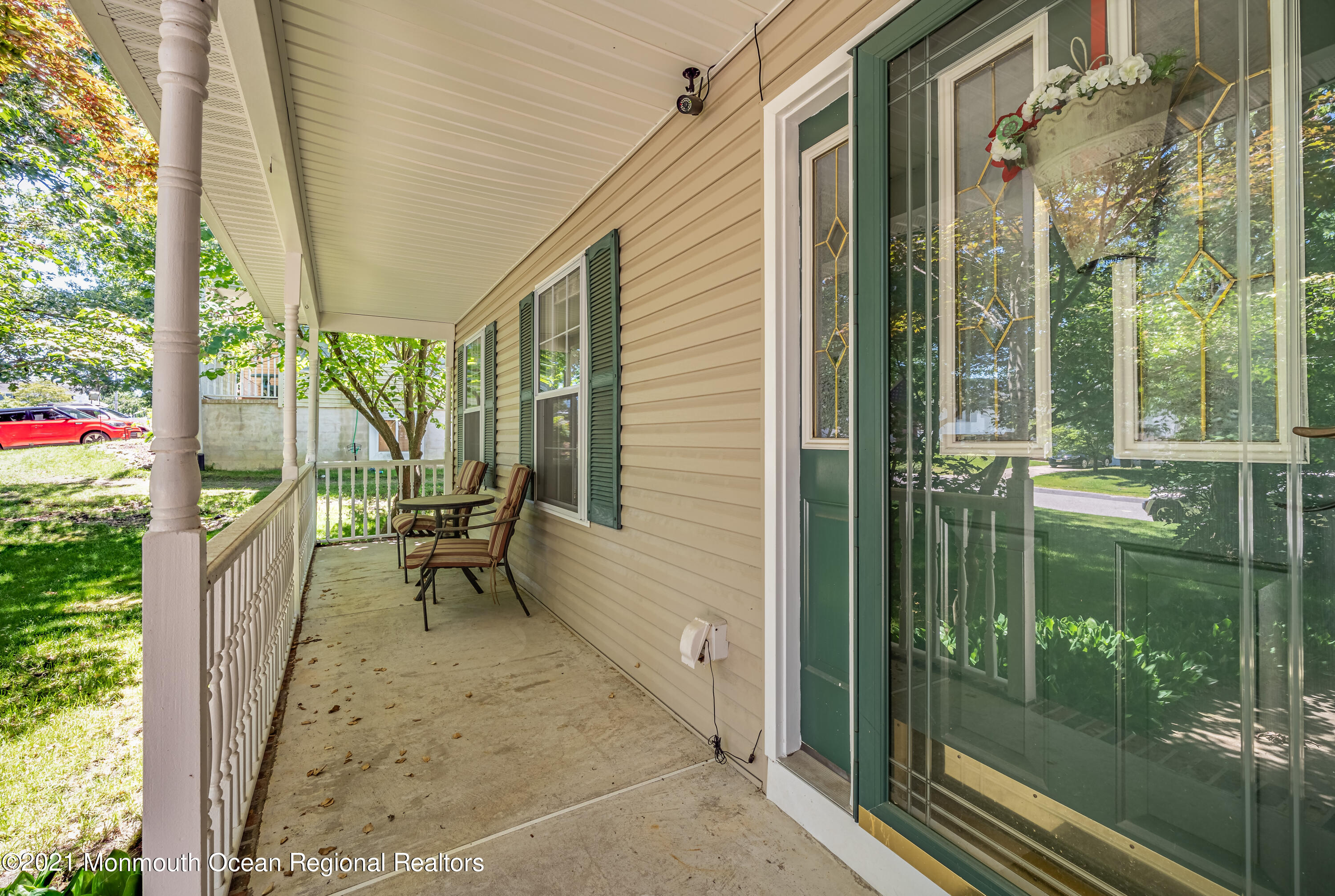 217 Topside Road Manahawkin, NJ 08050 - Photo 4 of 35 a porch with a table and chairs