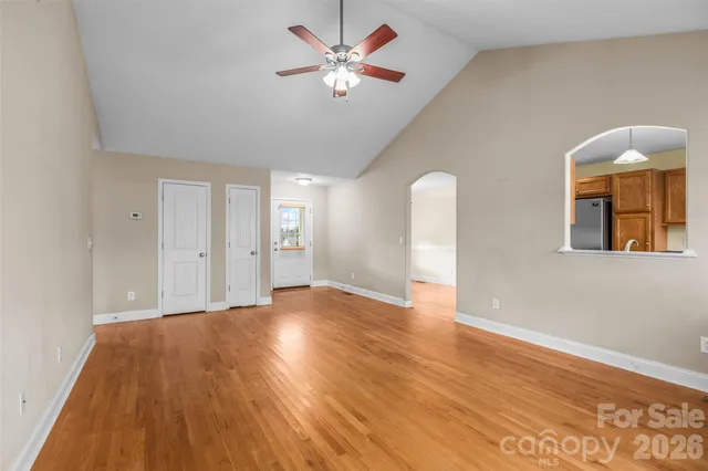 a kitchen with granite countertop stainless steel appliances a refrigerator a stove top oven and sink