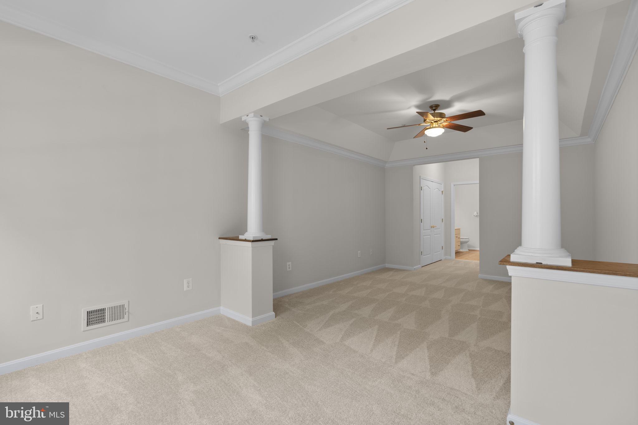 7315 Maplecrest Road, Unit 104 Elkridge, MD 21075 - Photo 27 of 58 an empty room with a windows and ceiling fan
