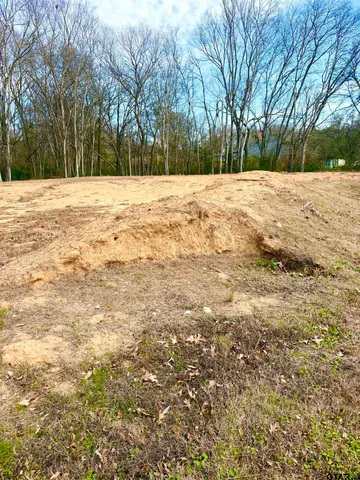 a white house covered with snow in front of house