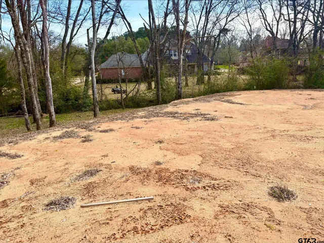 a wooden bench sitting in middle of a yard