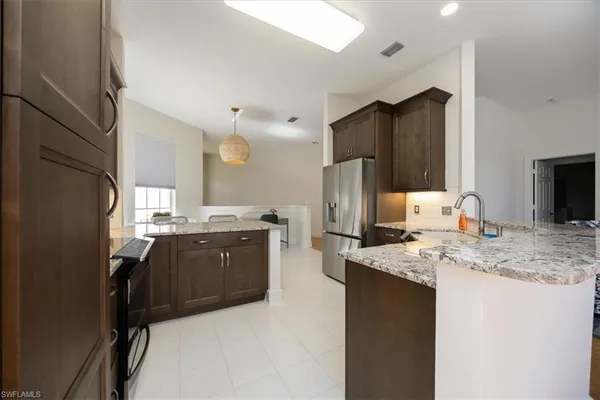 a kitchen with refrigerator and cabinets